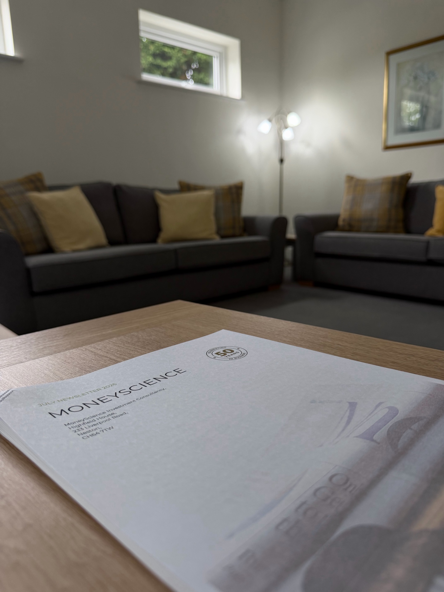 A MoneyScience consultation room in Neston, showing a professional meeting space with comfortable seating and financial documents